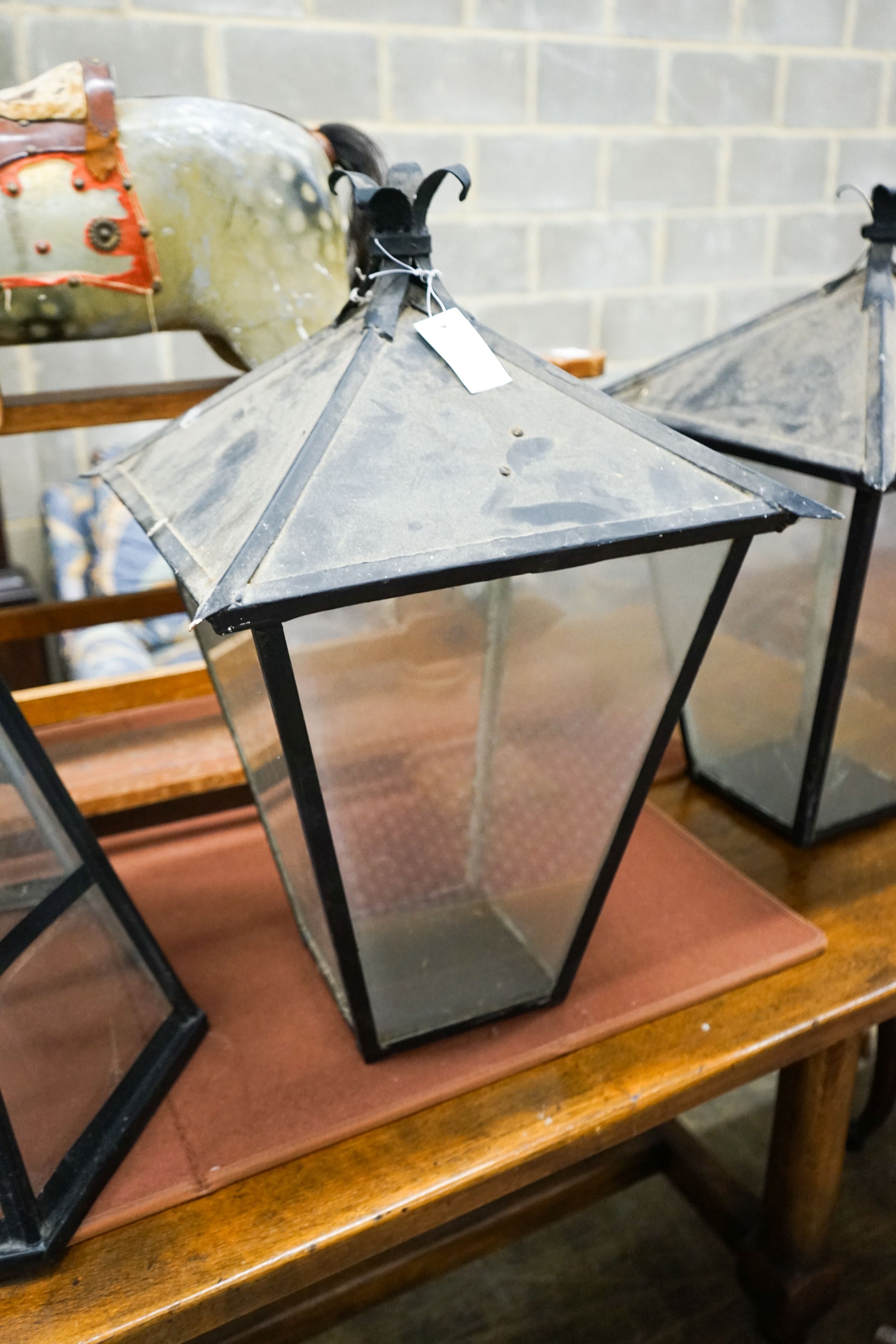 A pair of Victorian style black metal square lanterns, height 68cm together with one other and a reproduction convex wall mirror